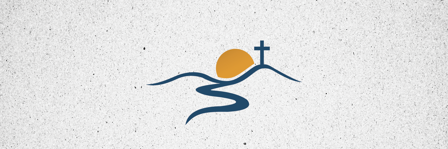 The sun rises behind a hill topped by a cross, with a curved road leading toward the viewer's viewpoint